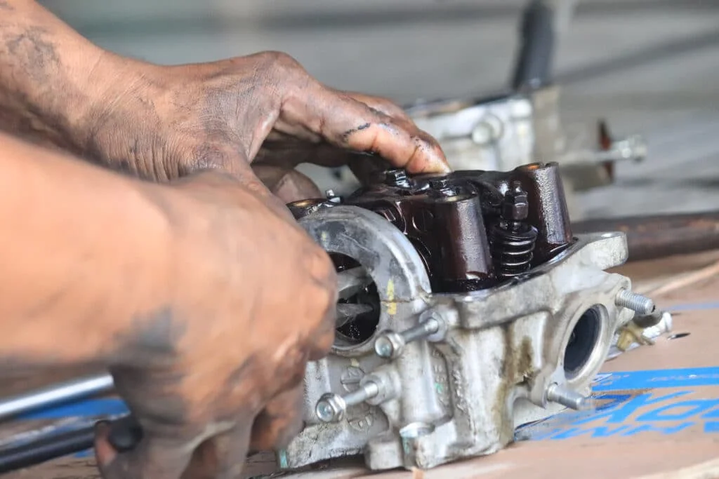 Car mechanic repairing an engine part