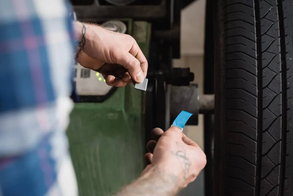Installing a tape on wheel weight