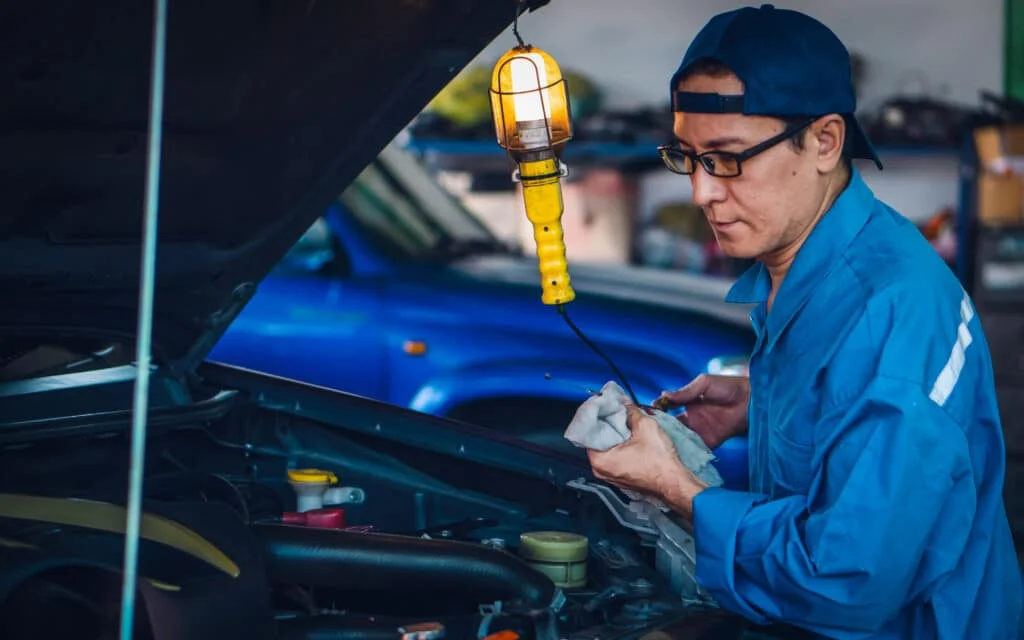Man using an automotive work light with a hook