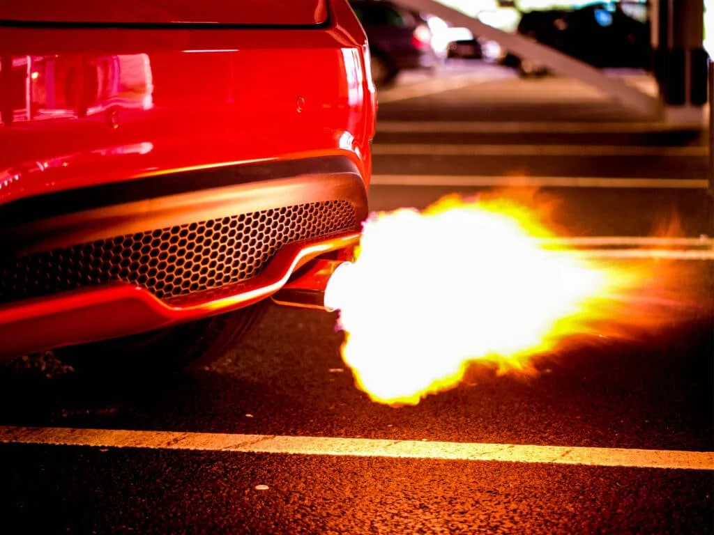 A tailpipe spitting flames