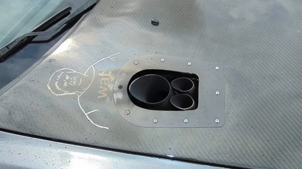 Hood exit exhaust system