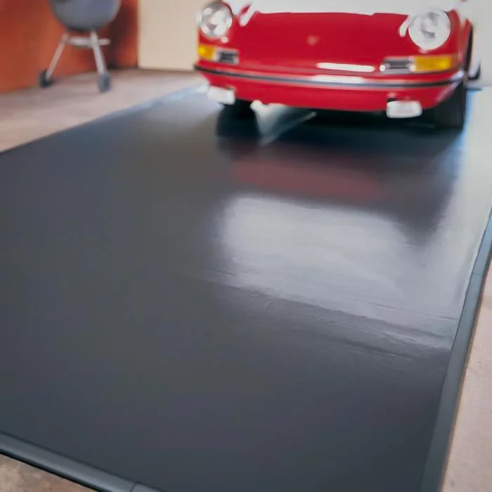Porsche parked on garage floor mat