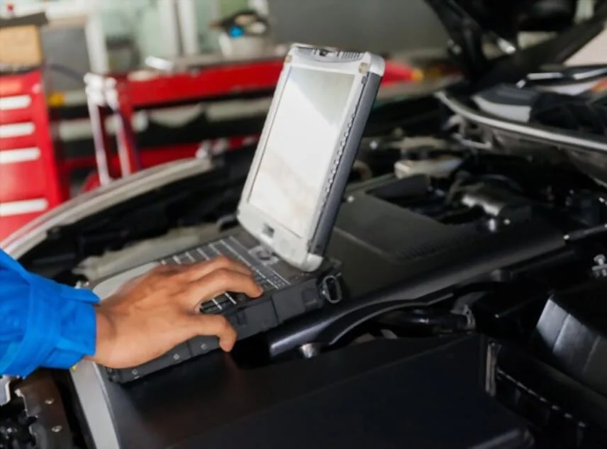 Technician tuning a car