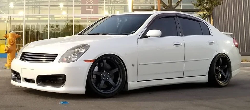 White G35 sedan on black Gram Lights 57CR rims