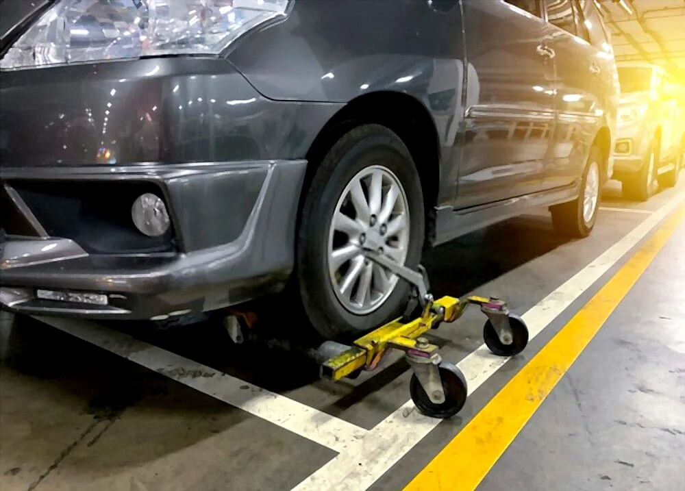 Minivan parked on a wheel dolly