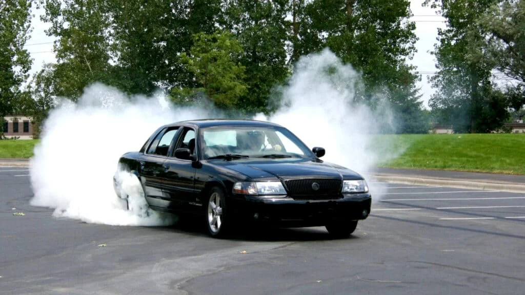 Black Mercury Marauder sleeper doing a burnout