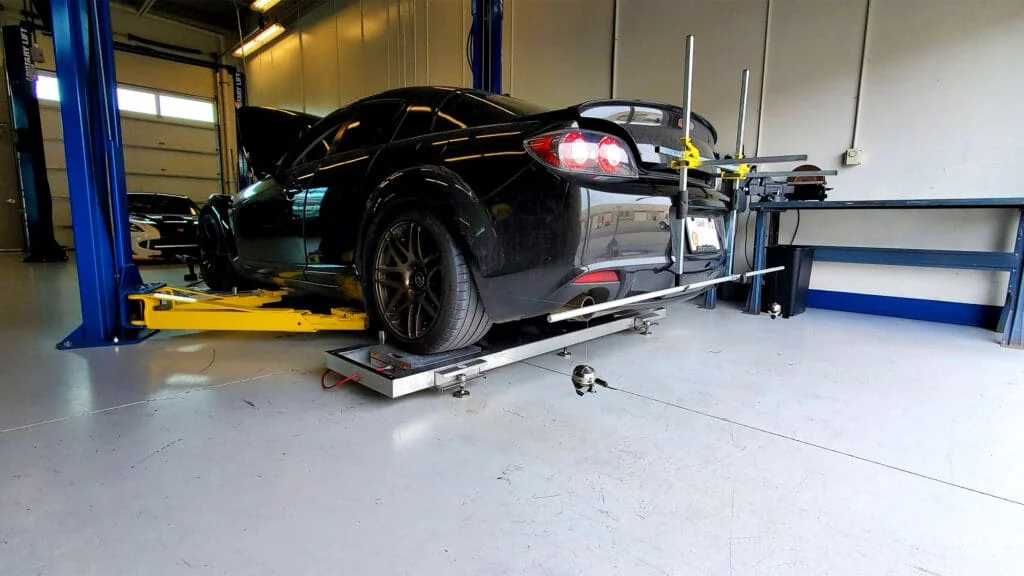 Corner balancing a black Mazda RX8.