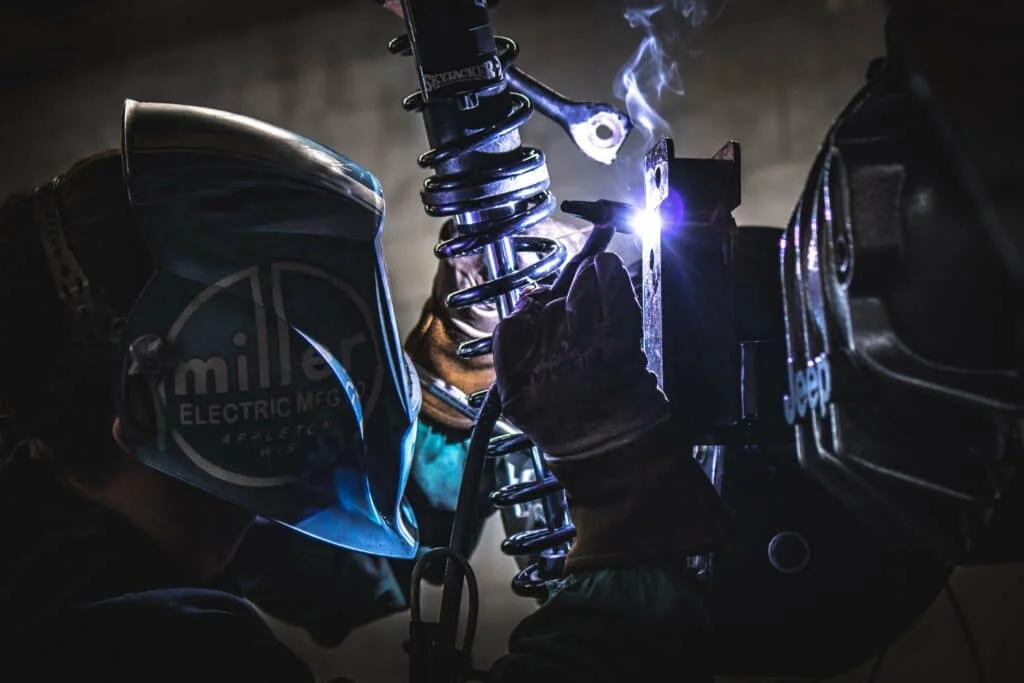A technician welding mounting points for suspension
