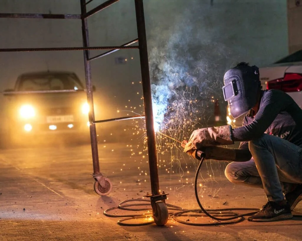 A man welding in a home garage