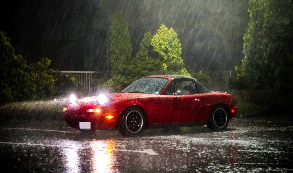 Red NA Miata in the rain