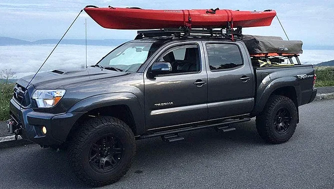 Toyota tacoma hauling a canoe and camping gear