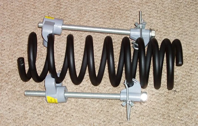 External compressor attached to a coil spring