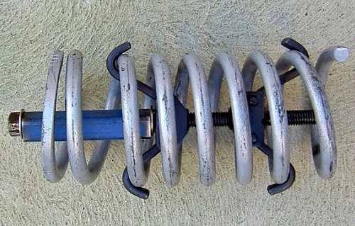 Internal compressor attached to a coil spring