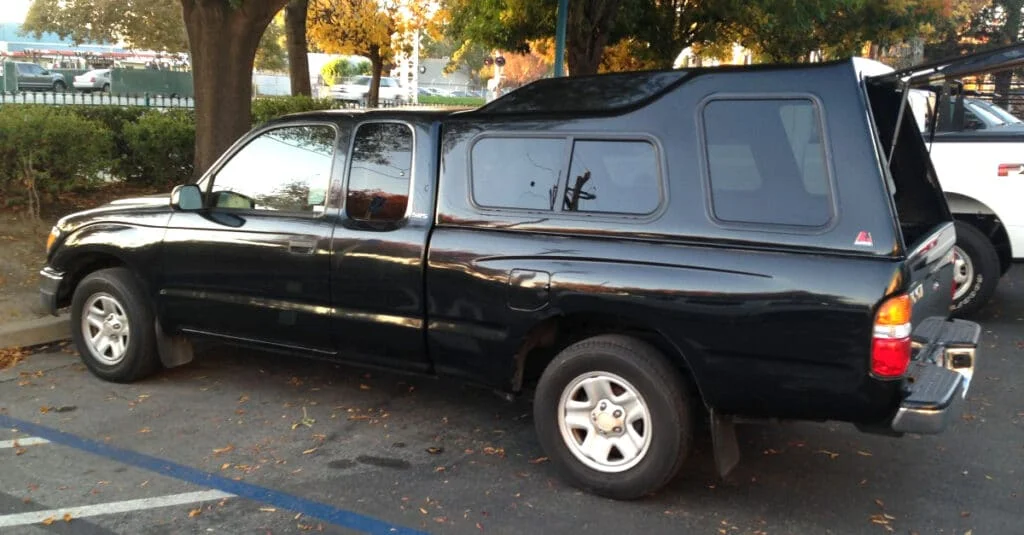 Tall camper shell installed on a Tacoma