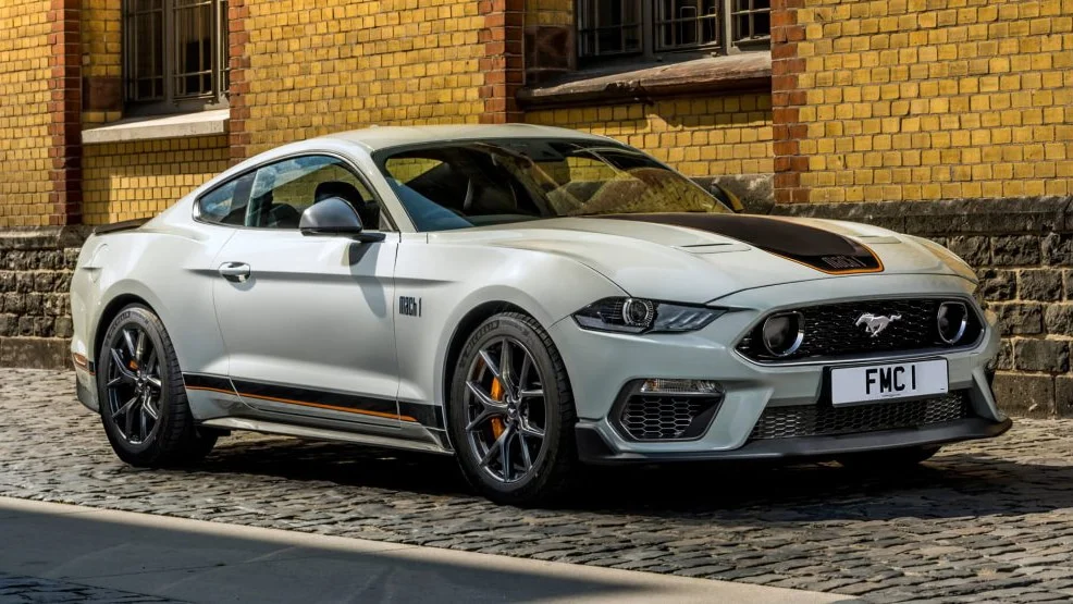 A Ford Mustang Mach 1 with orange-accented black racing stripes