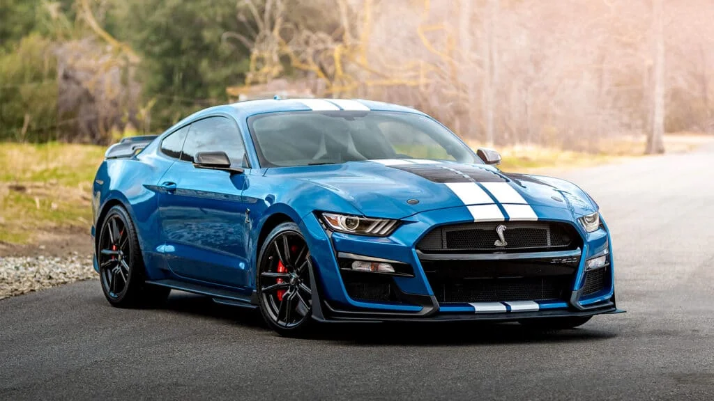 Blue Mustang Shelby GT500 with dual-white racing stripes and red brake calipers