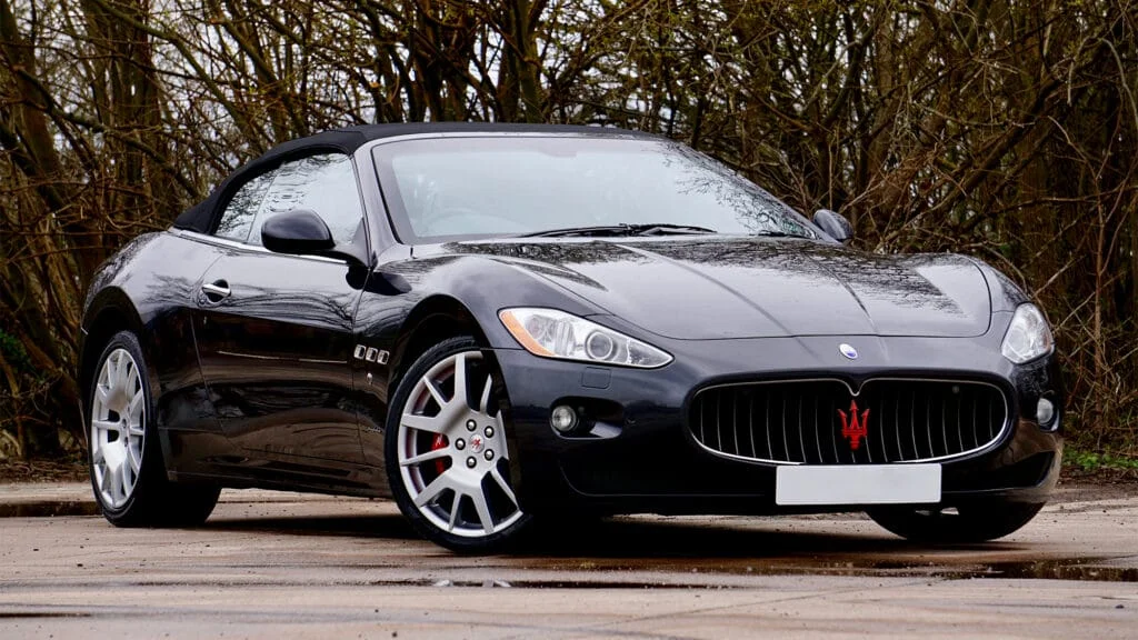 A black Maserati GranTurismo with a soft top