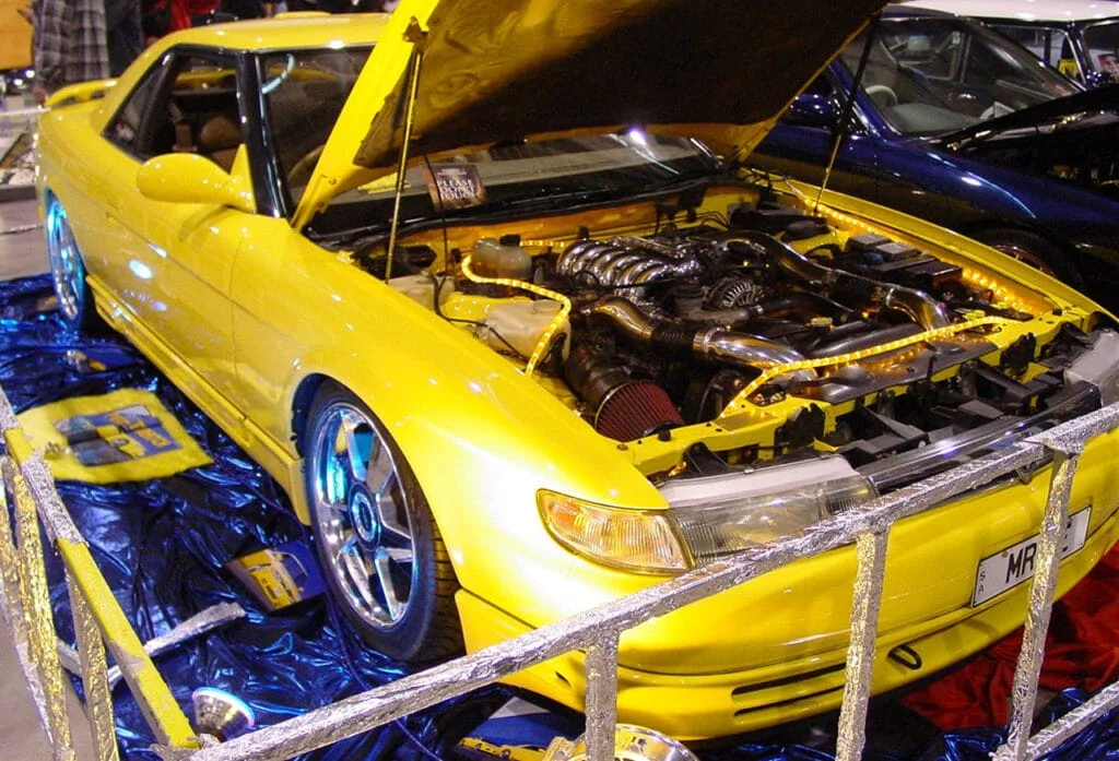 Mazda Eunos Cosmo with a popped hood showing off the 20B engine
