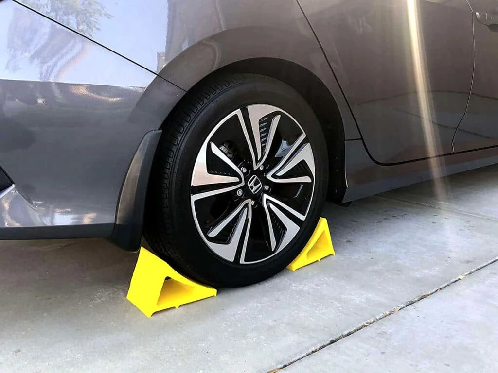 Car parked and immobilized using yellow wheel chocks