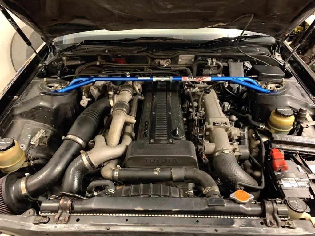 1JZ engine bay with blue cusco strut bar
