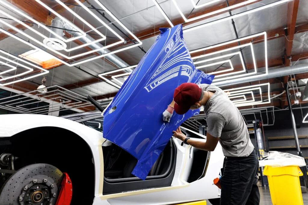 Sportscar door being wrapped blue