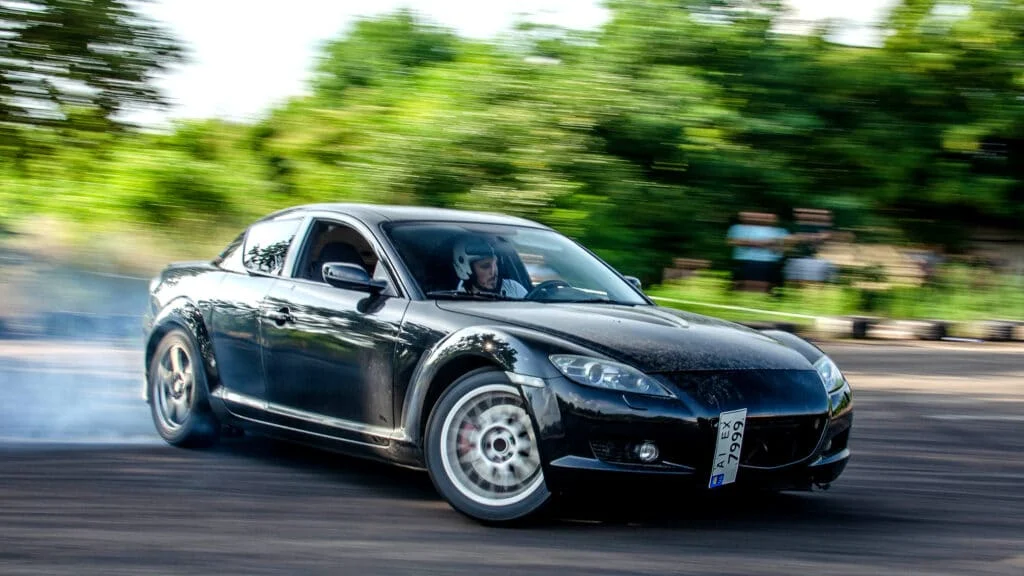 Black RX8 drifting at a track