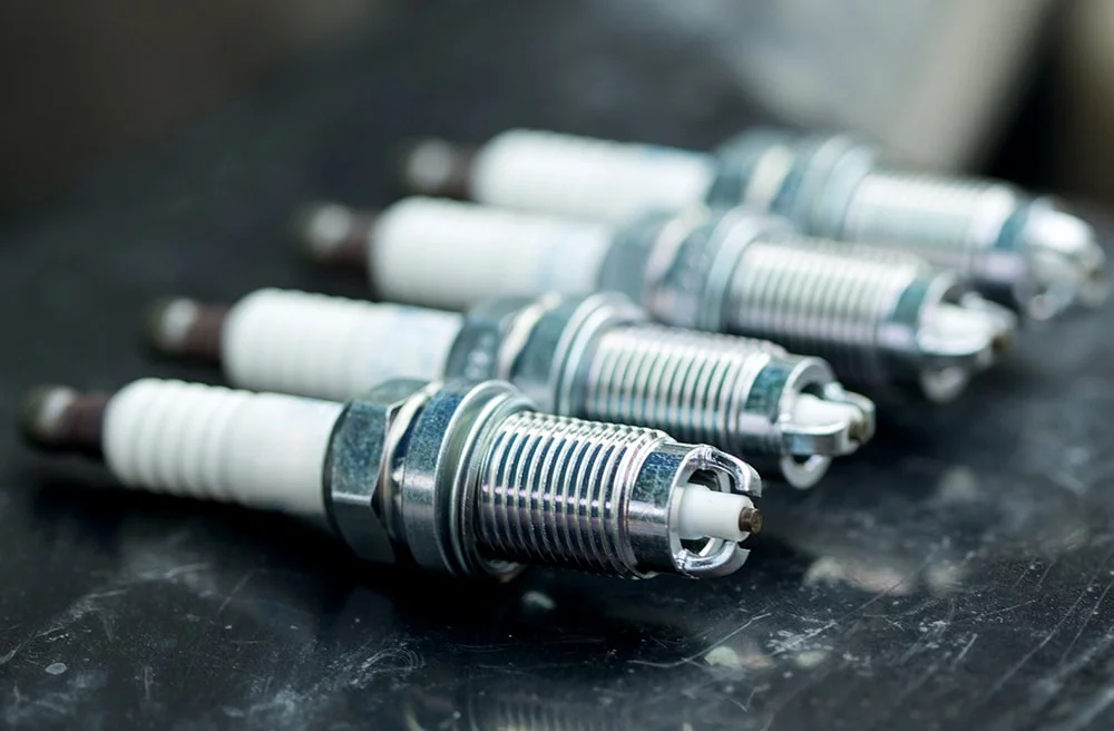 New and clean spark plugs laid out on a table