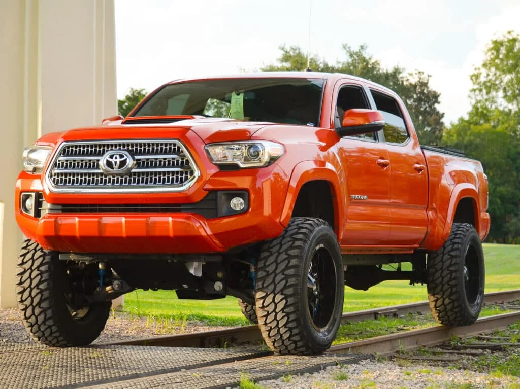 Red Gen 3 Tacoma on aftermarket tires