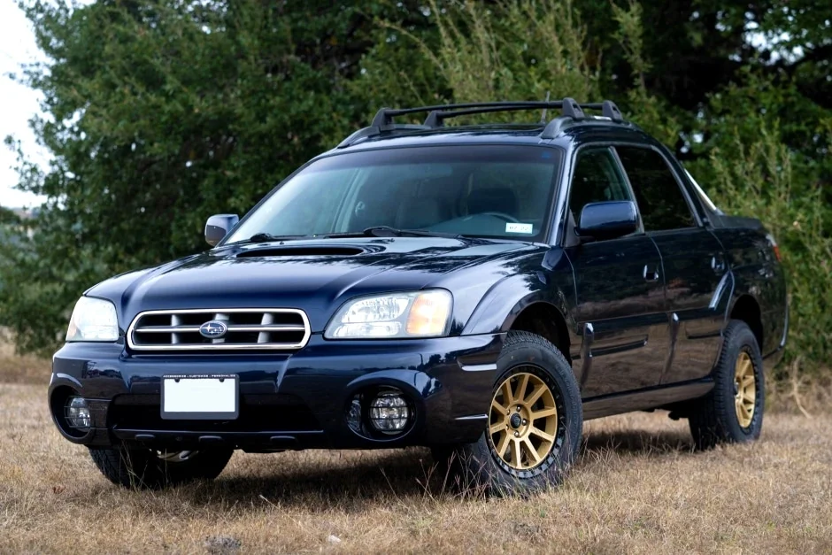 Black Subaru Baja with gold rims