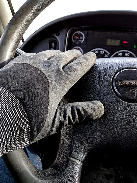 Comfortable driving gloves on a steering wheel