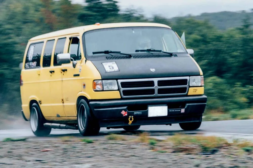 Yellow Dajiban van on a race track