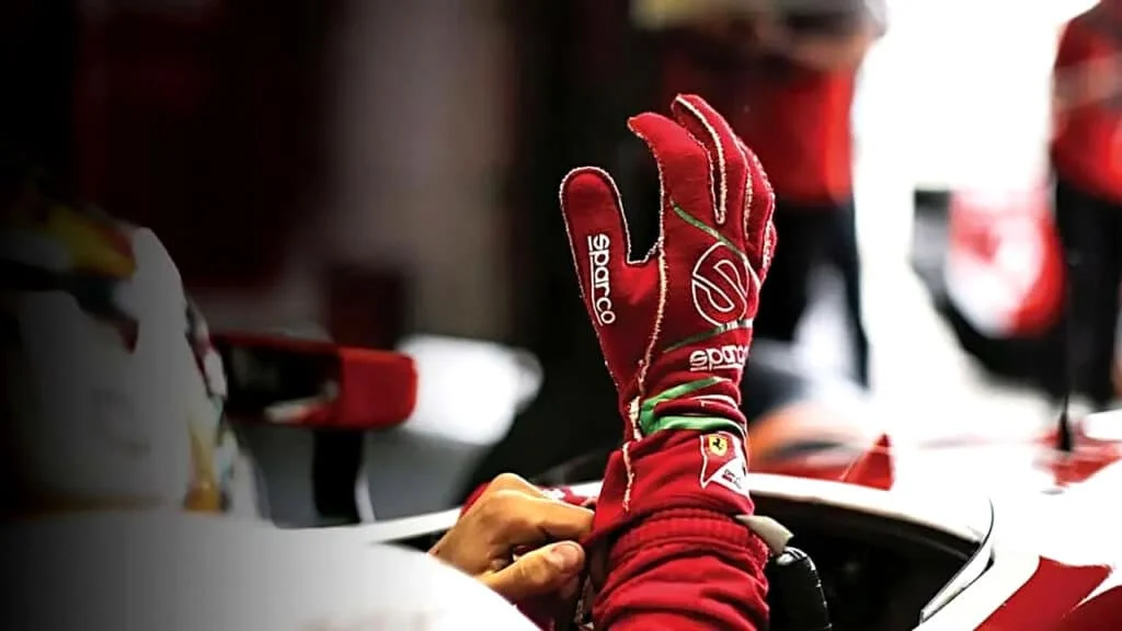 Racer putting on red Sparco racing gloves