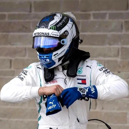 Formula 1 racer taking off their racing gloves