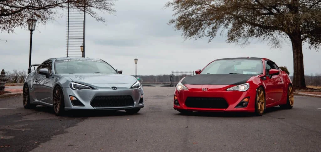 Silver Toyota FT-86 parked next to a red Scion FRS