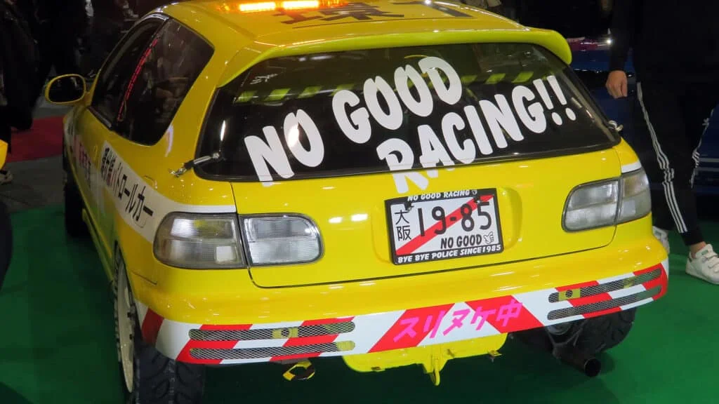 Yellow Civic EG6 with No Good Racing decals and a temporary number plate