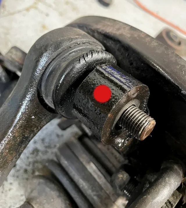 Steering knuckle with marked spot for hammering the ball joint out