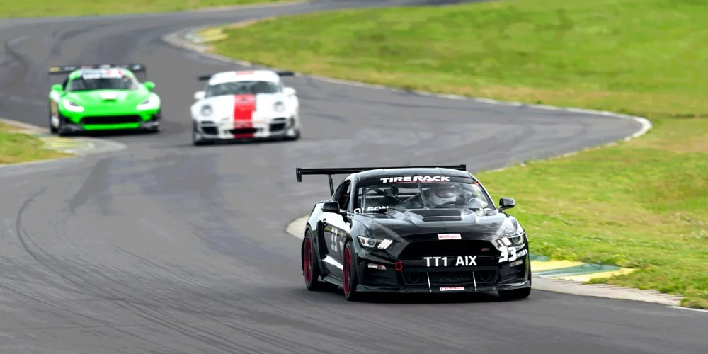 Black Mustang taking the lead at a Time Attack race