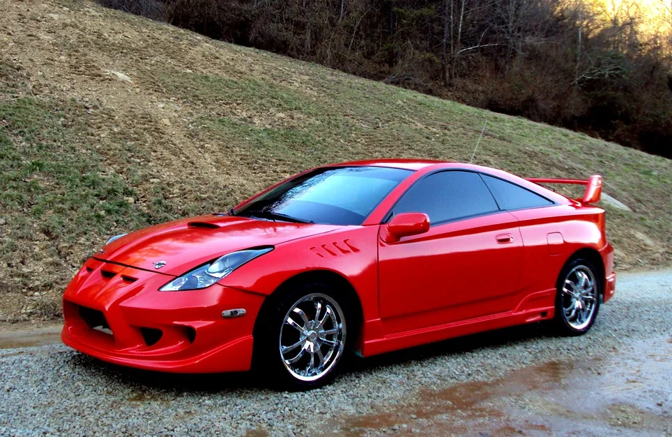 Red Toyota Celica GT-S with chrome rims