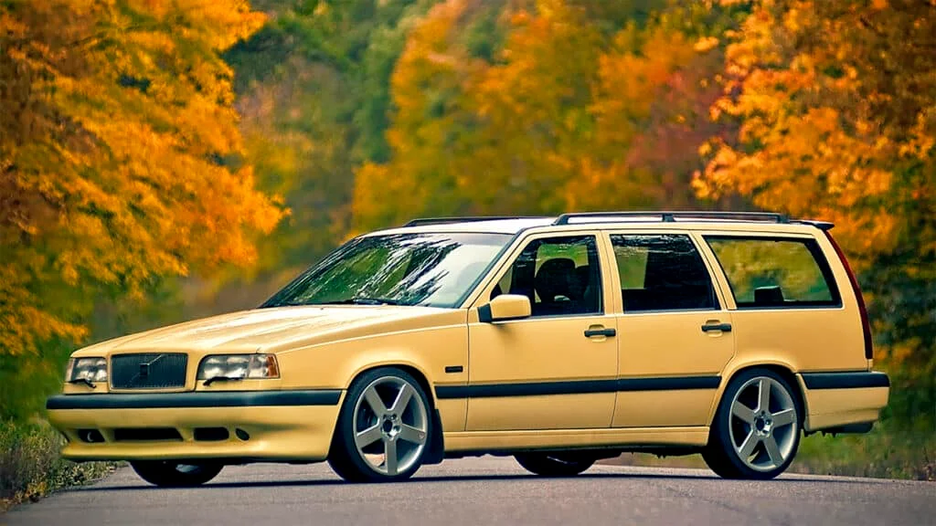 Lemon yellow Volvo 850R wagon on a scenic road