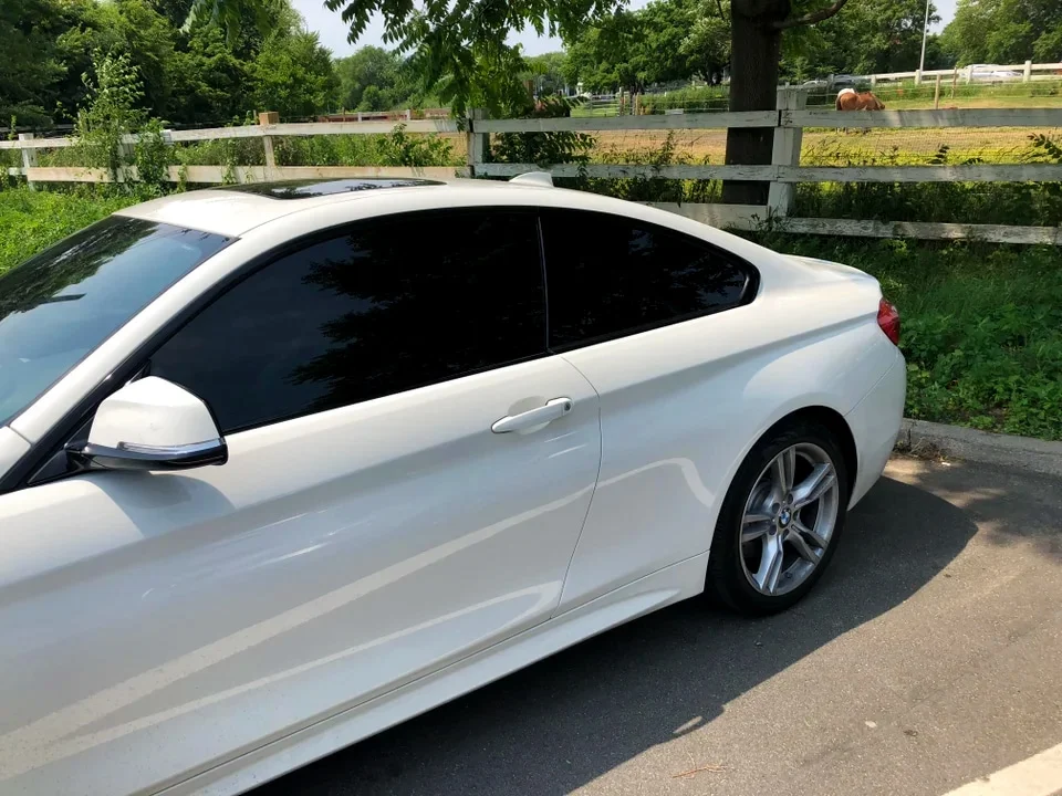 White BMW with dark black window tint