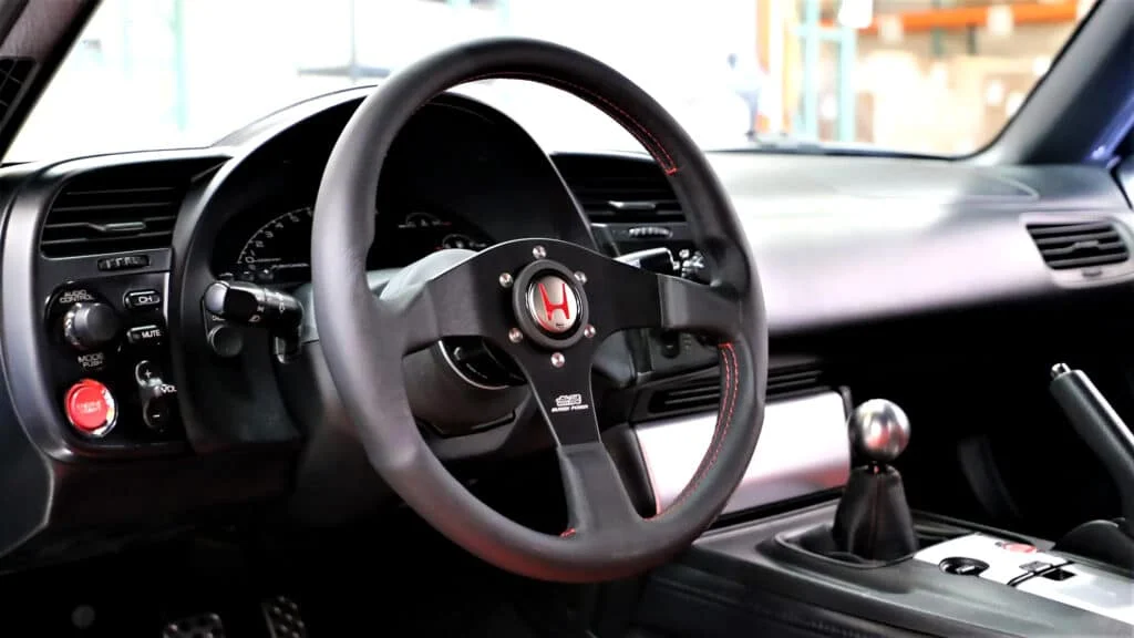 OEM+ style aftermarket steering wheel installed in a Honda S2000