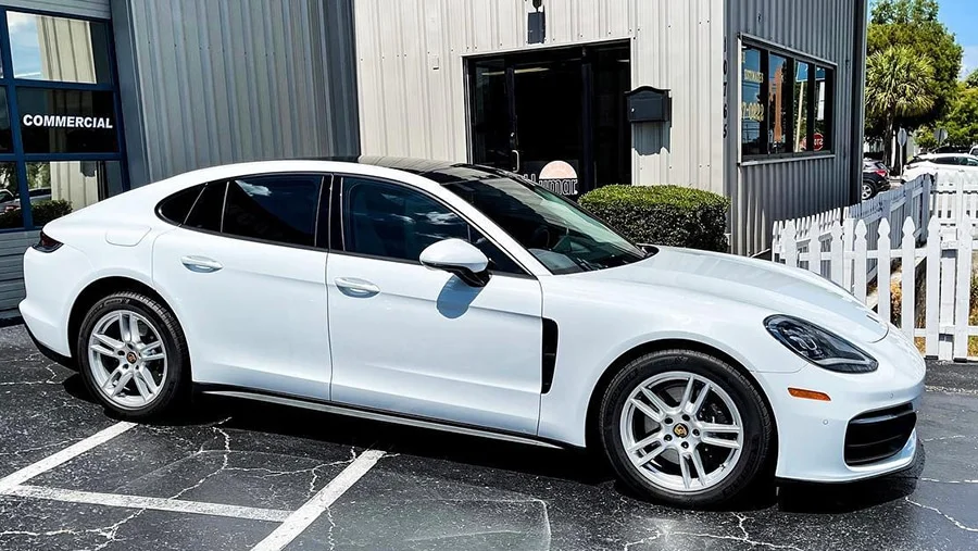 White Porsche Panamera with reflective window tint.