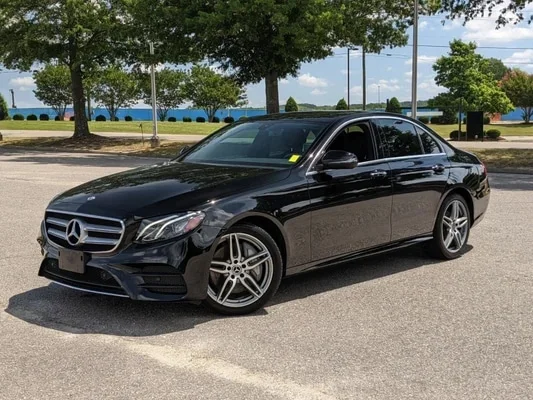 Black Mercedes-Benz S-Class with dark tinted windows.