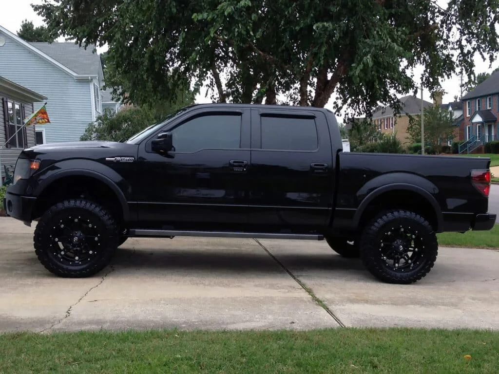 All-black Ford F150 with dark tinted windows.