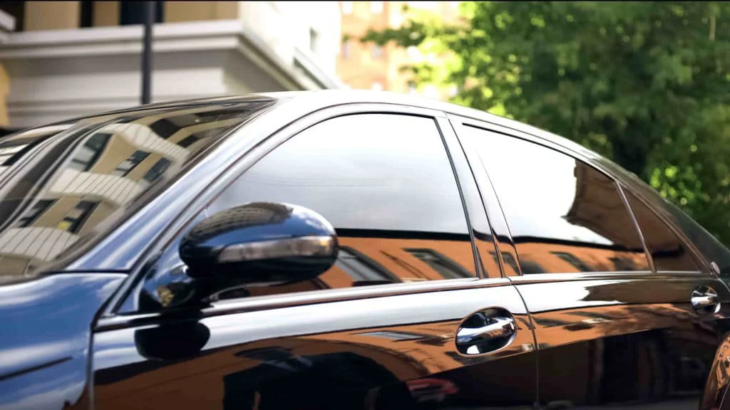 Black sedan with dark black tinted windows in Texas