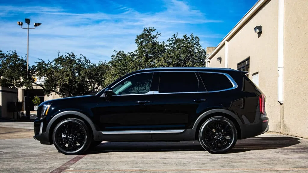 Black SUV with dark black window tint in Kansas