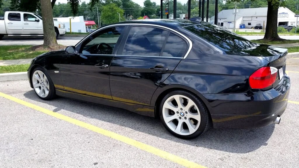 Black BMW 3-Series with dark tinted windows