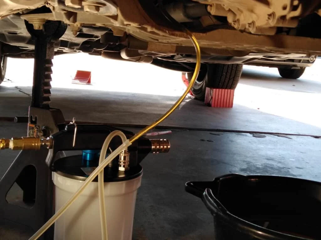 Pneumatic brake bleeder in use