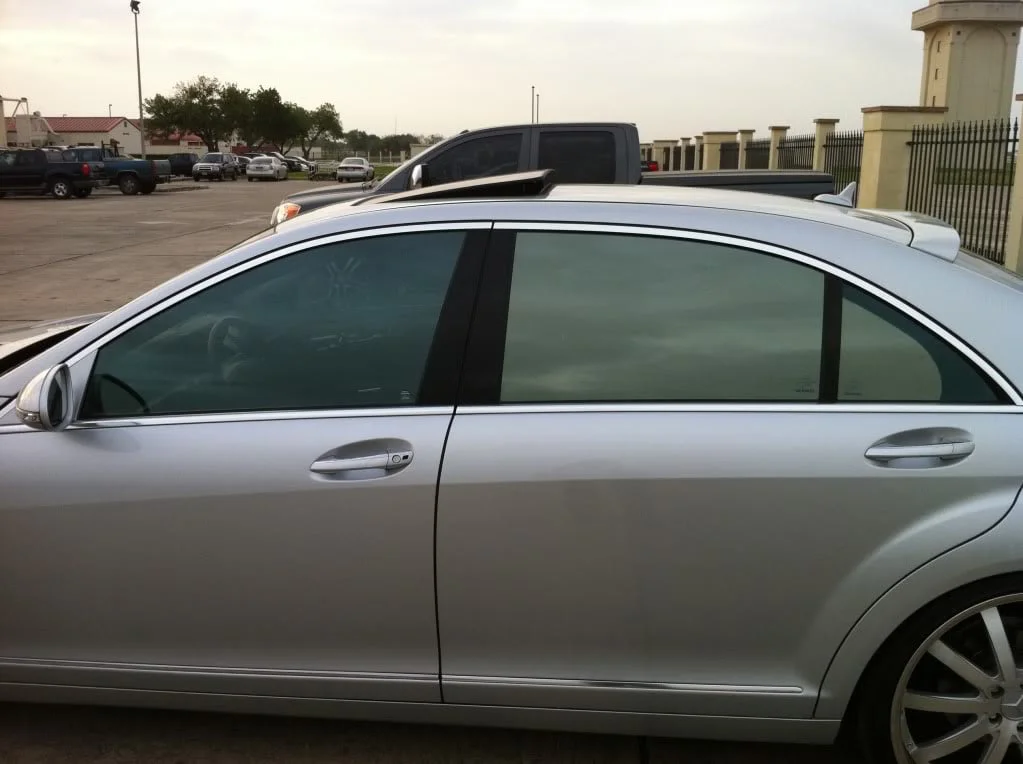Silver sedan with varying reflective tint
