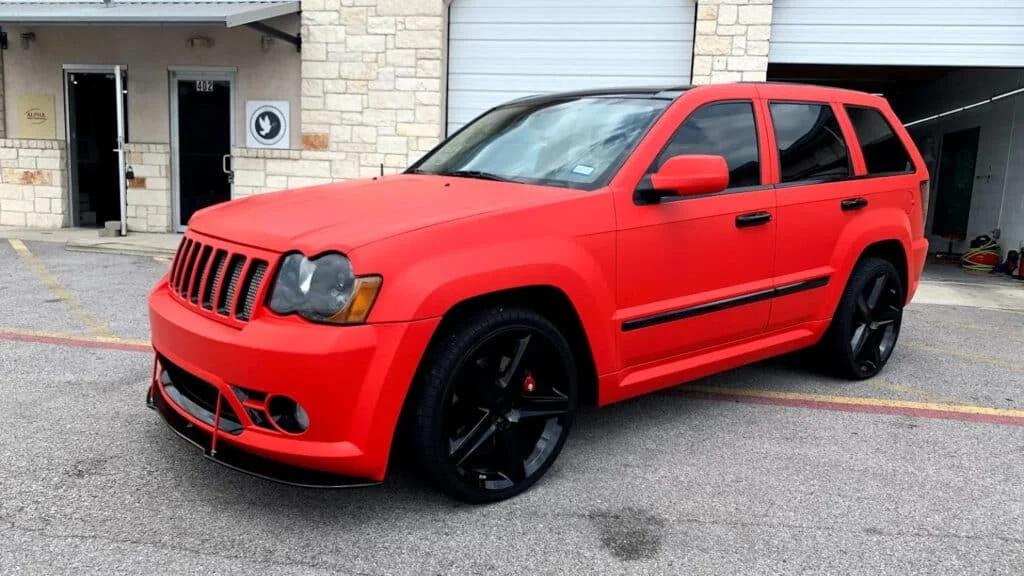 Matte red SUV with tinted windows